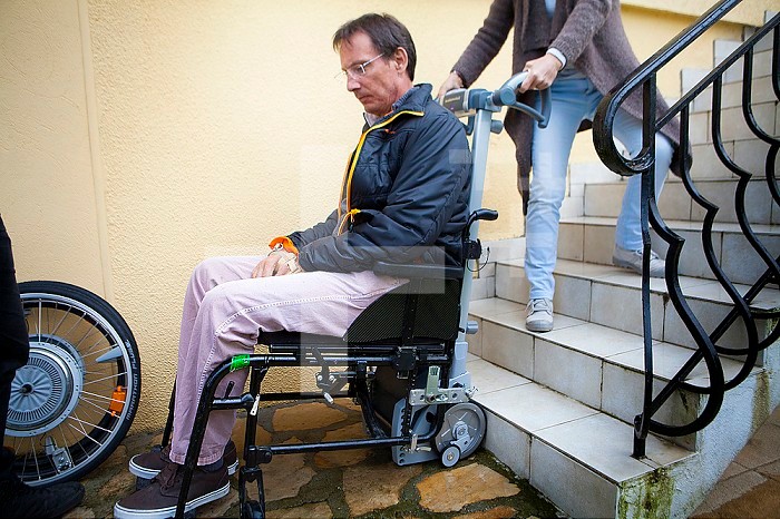 Vance is tertraplegic, he uses a scalamobil® (a mobile motorized stair lift) to climb the stairs in his house, with the help of his wife.