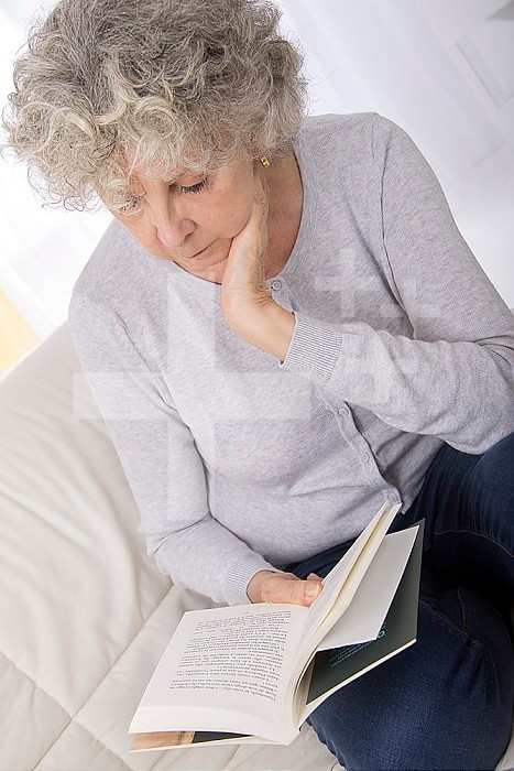 Senior woman reading a book.