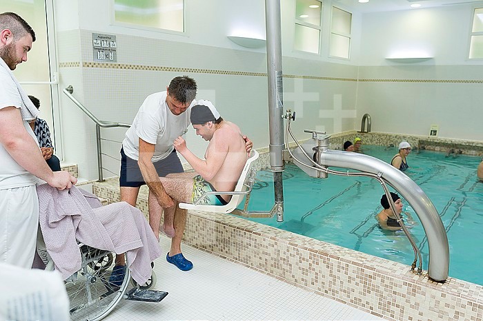 Reportage at the thermal baths in Lamalou-les-Bains, France. Leroy Pavilion, care service devoted to neurological disorders. The hydrotherapist uses the hydraulic seat.