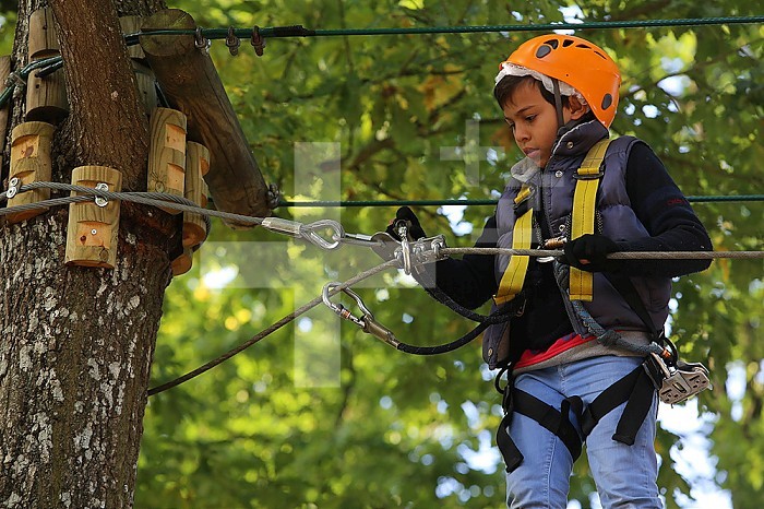 10-year-old boy on a rope course. France.